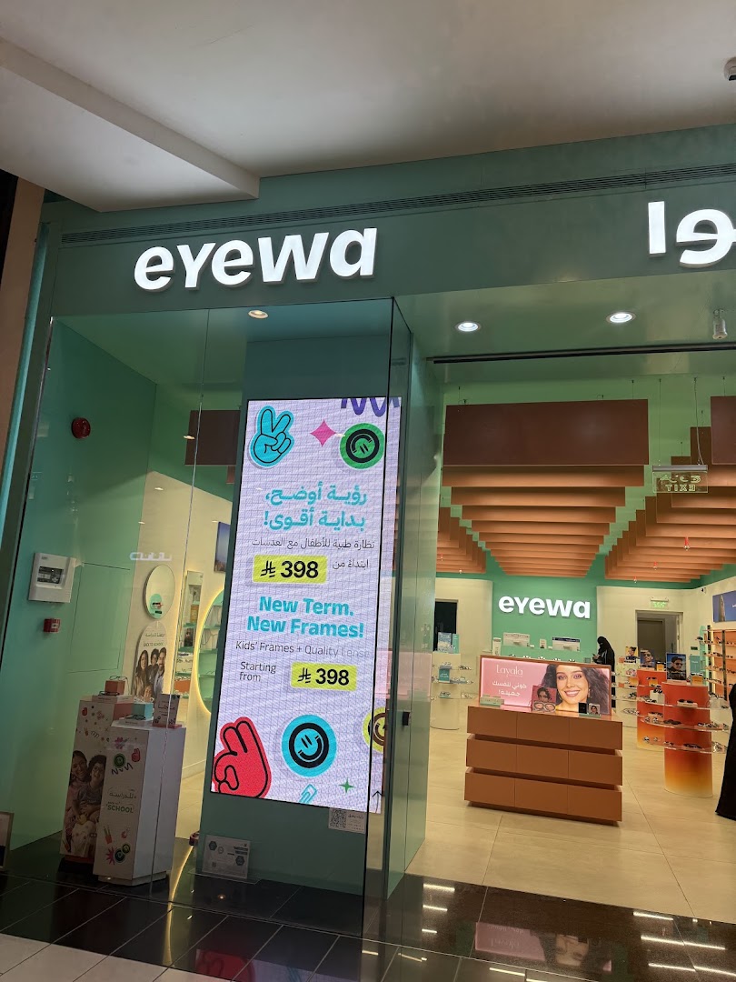 The storefront of Eyewa, an optical shop, featuring a bright interior and promotional displays.