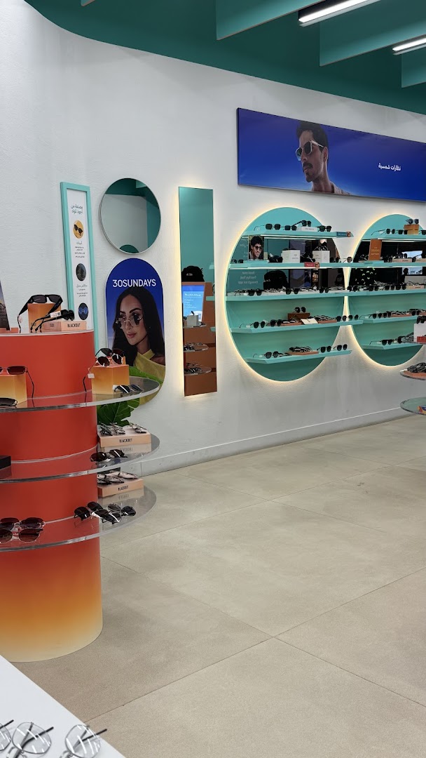 Interior view of an Eyewa store showcasing a wide selection of sunglasses on display shelves.