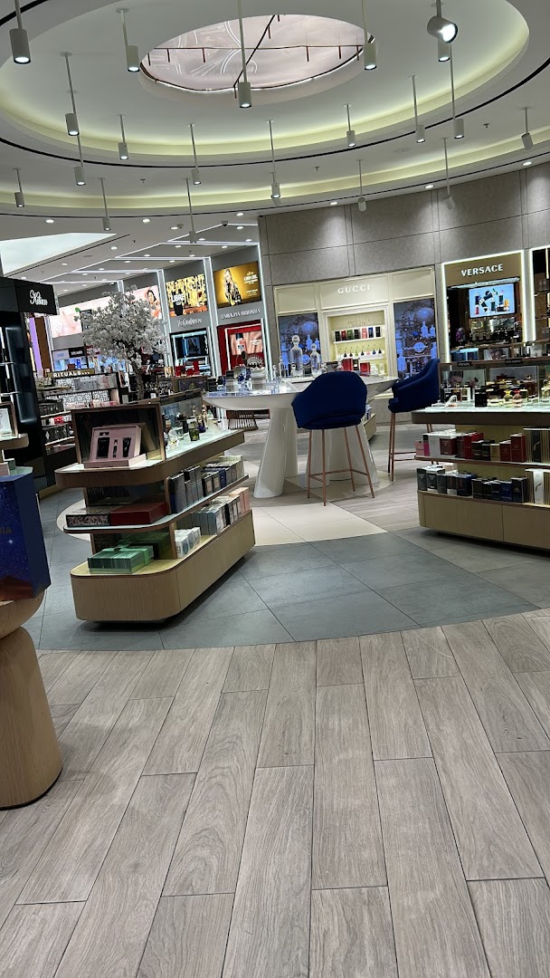 Interior view of a luxury beauty and fragrance store with branded displays.