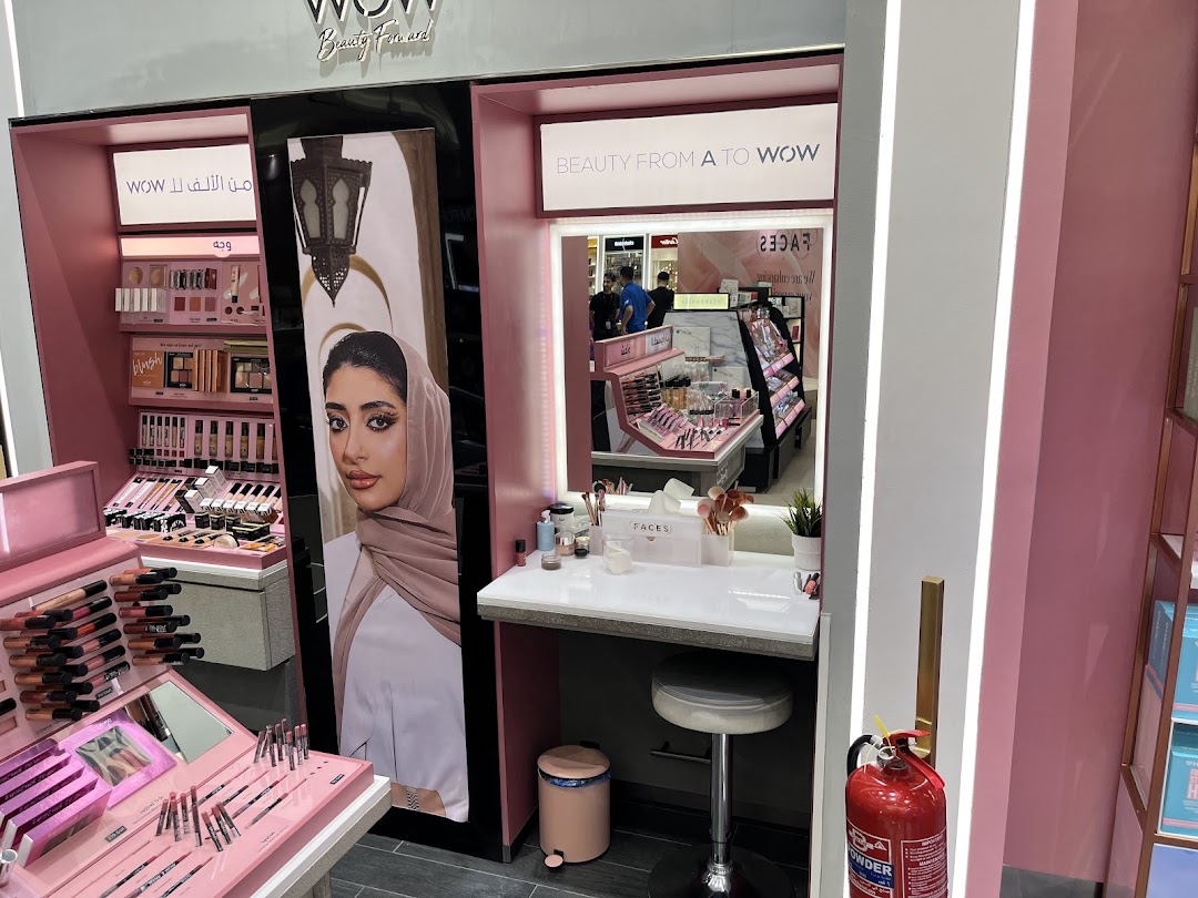 A beauty store display featuring makeup products, a model's image, and a makeup station.