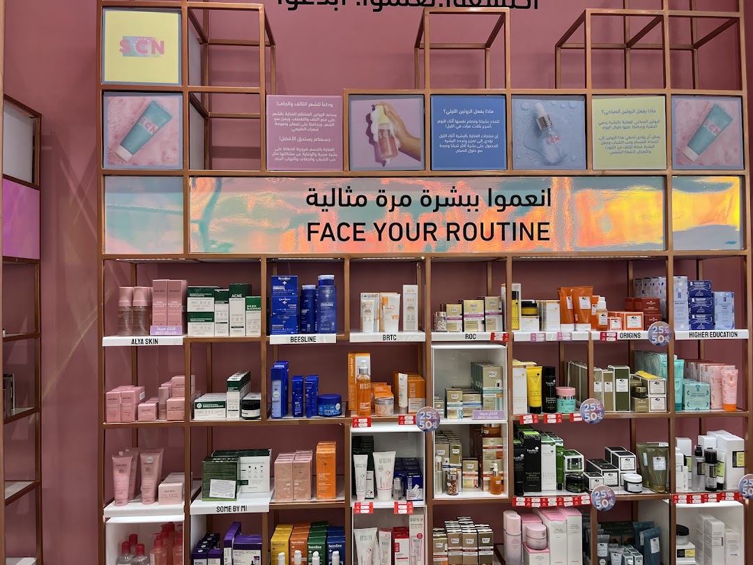 A well-organized display of skincare products on shelves, featuring various brands and promotional signage.