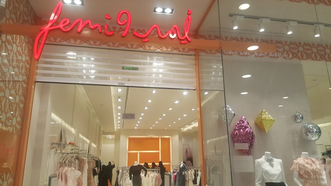The Femi9 shop front displays stylish women's clothing and mannequins in a well-lit interior.