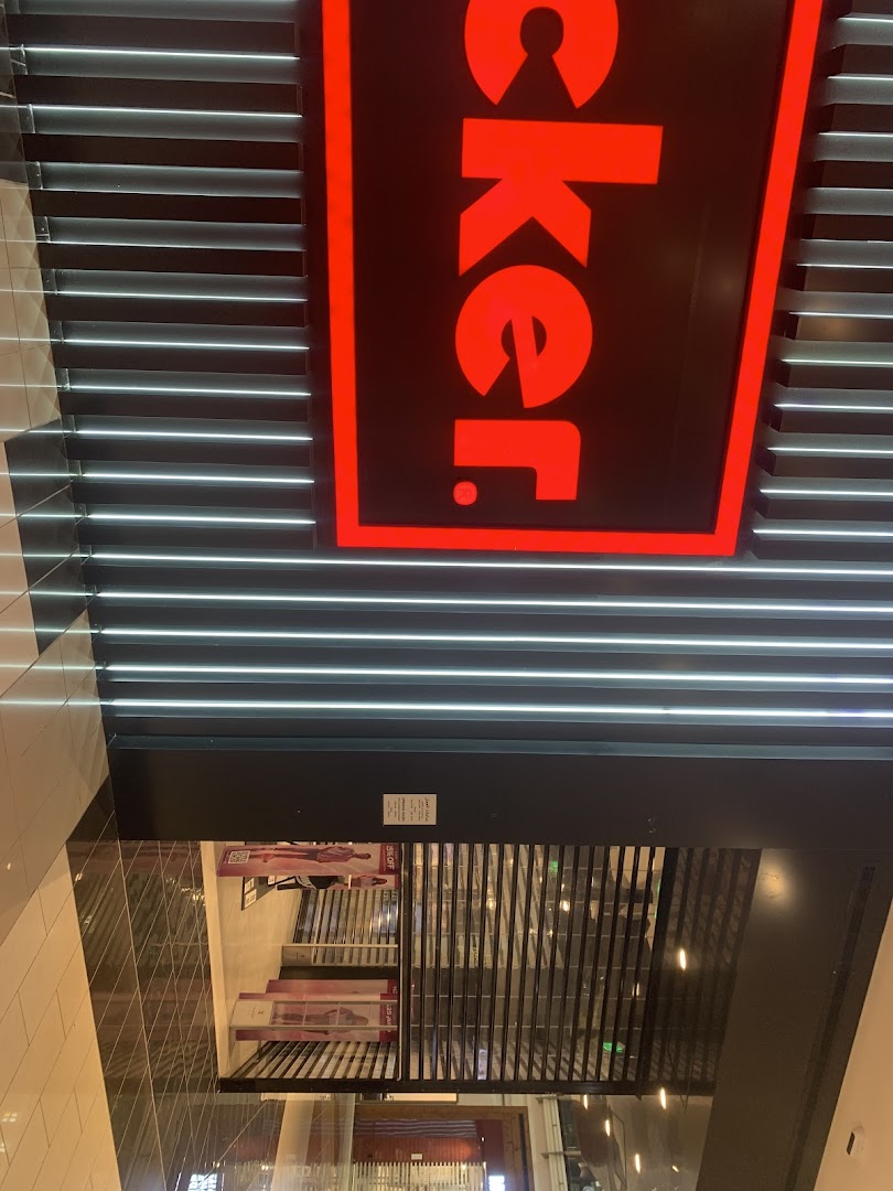 The entrance of a Foot Locker store with its prominent red and black signage.