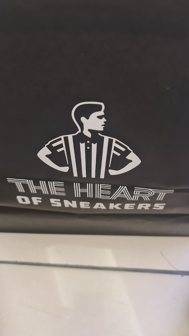 A black bag with white text and a graphic of a person wearing a striped shirt.