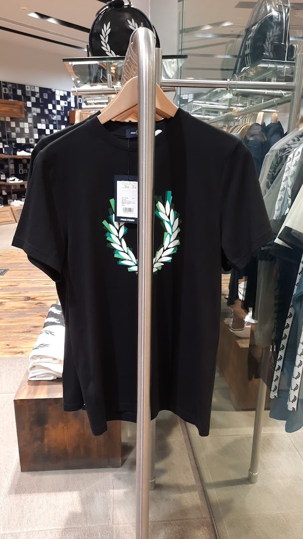 A black Fred Perry t-shirt with a green and white laurel wreath logo is displayed.