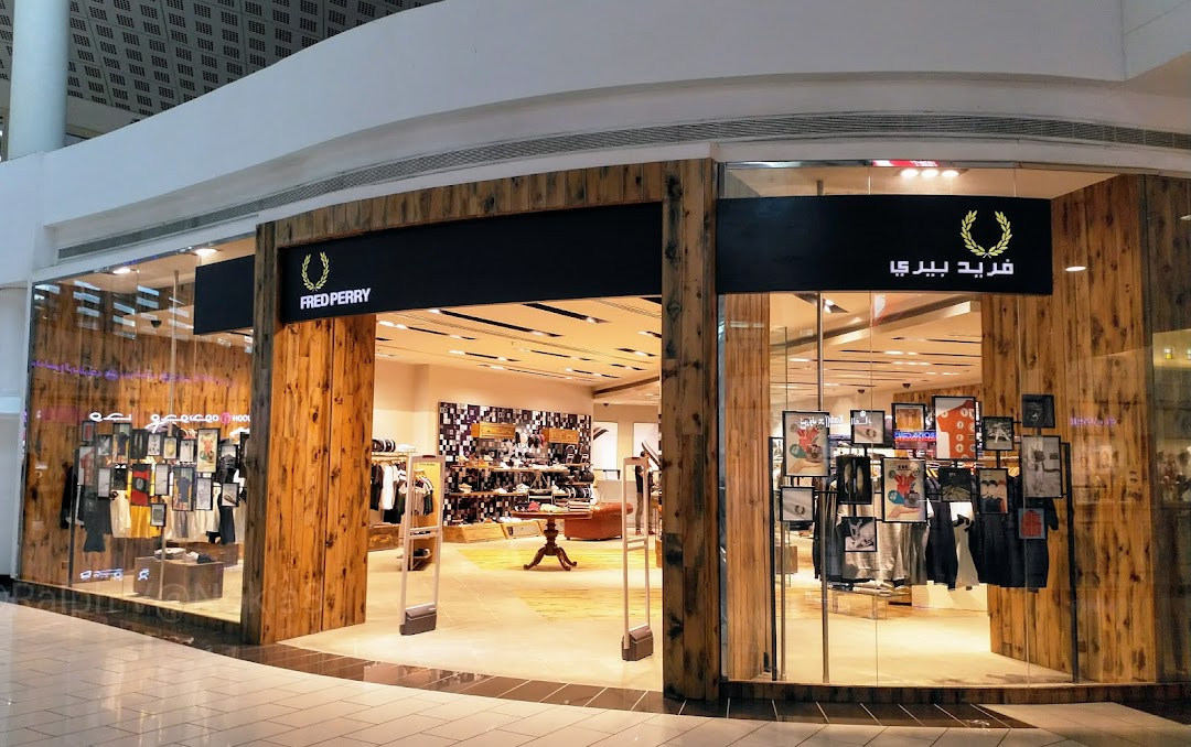The Fred Perry shop entrance with wooden accents and displayed apparel.