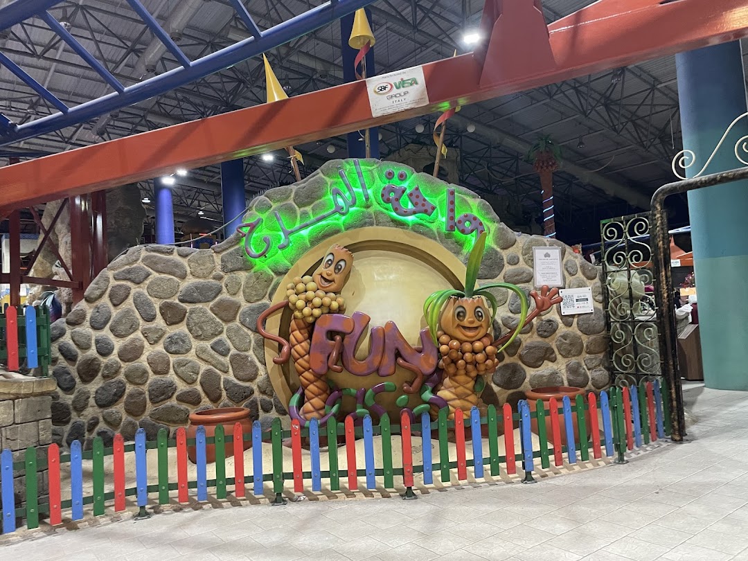 The entrance to Fun Oasis features cartoon characters and colorful fencing.