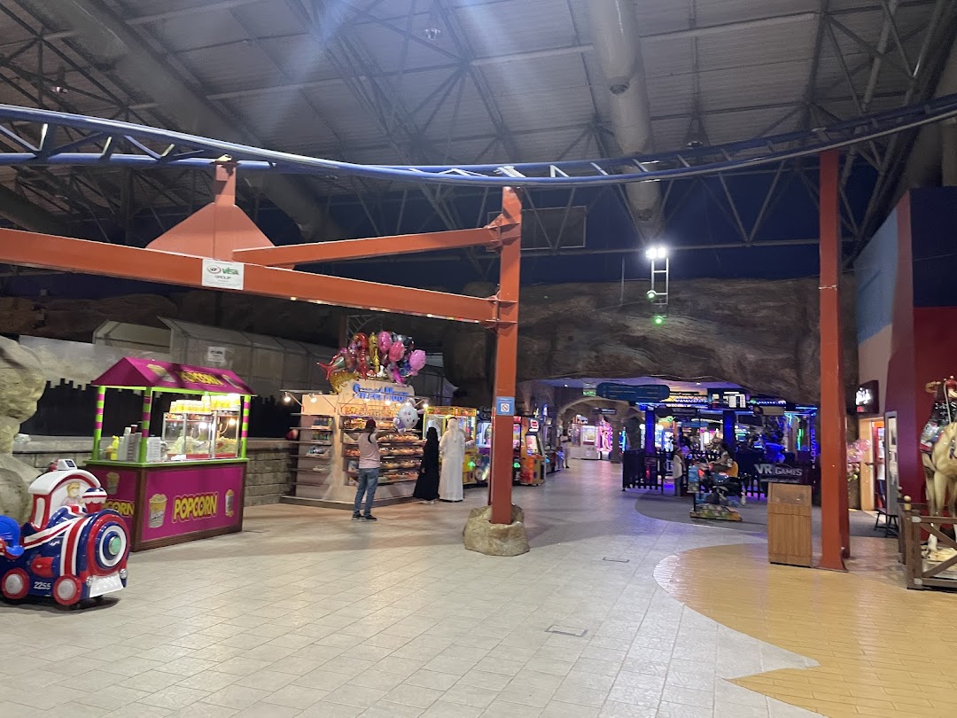 An indoor amusement area with arcade games, a popcorn stand, and VR games.