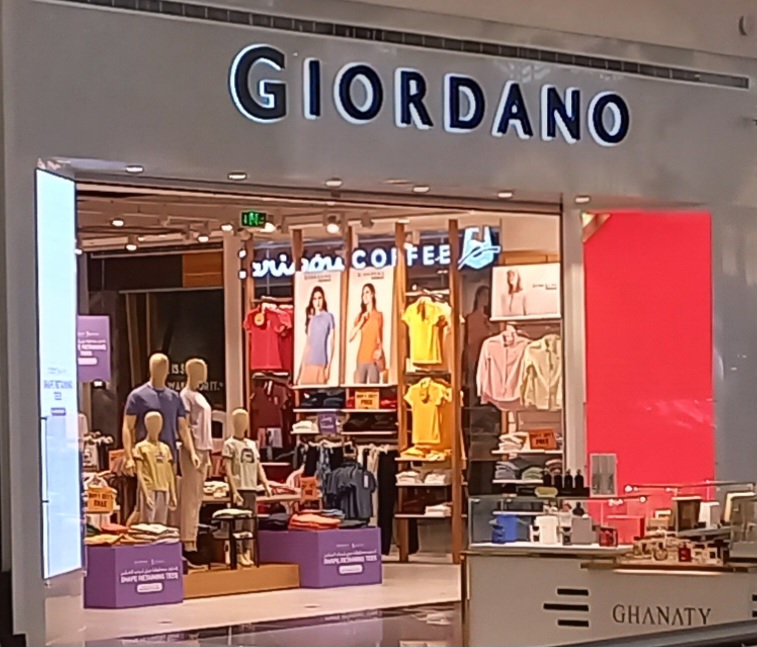 The GIORDANO shop front displays mannequins and various apparel items, including t-shirts and shirts.