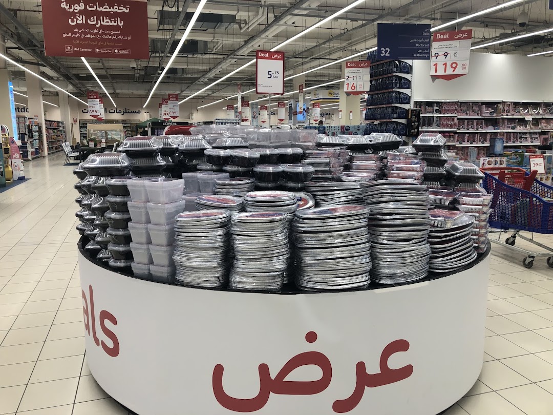 A display of disposable food containers and plates in a retail store.