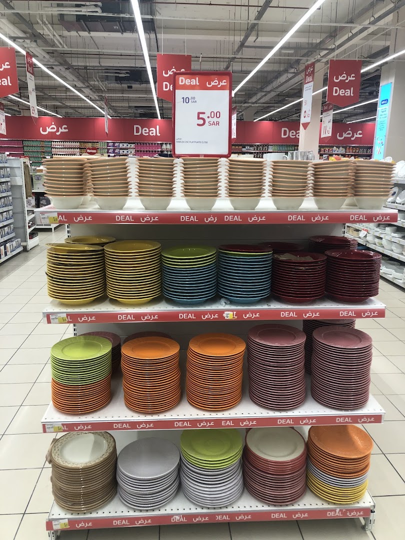 Shelves stocked with colorful plates and bowls, with 'Deal' signs indicating discounts.