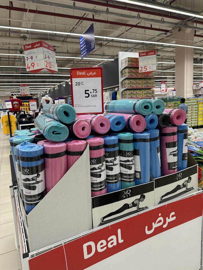 A display of colorful exercise mats on sale at a retail store.
