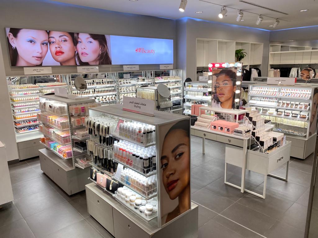 Interior view of an H&M Beauty store showcasing a wide selection of makeup and beauty products.