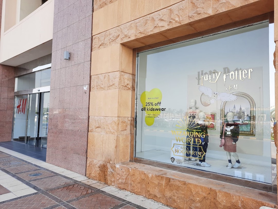 The H&M store entrance and a Harry Potter themed window display with mannequins.