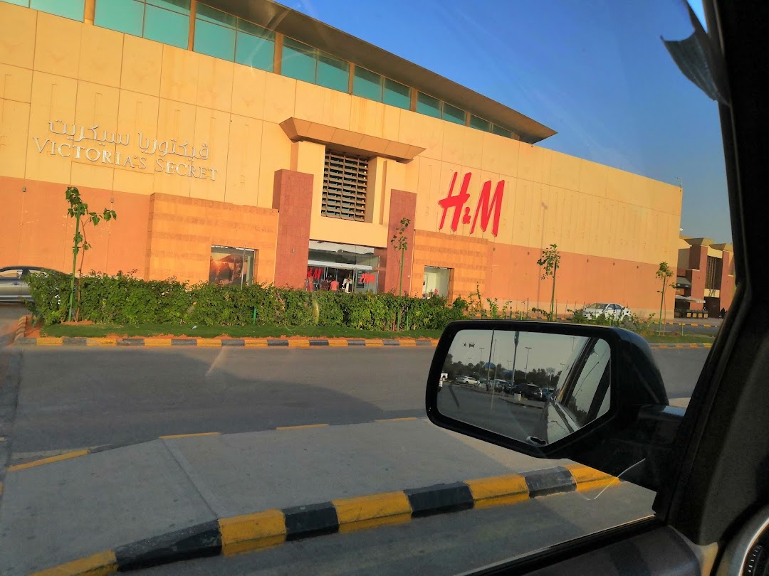 Exterior view of H&M and Victoria's Secret stores in a shopping mall.