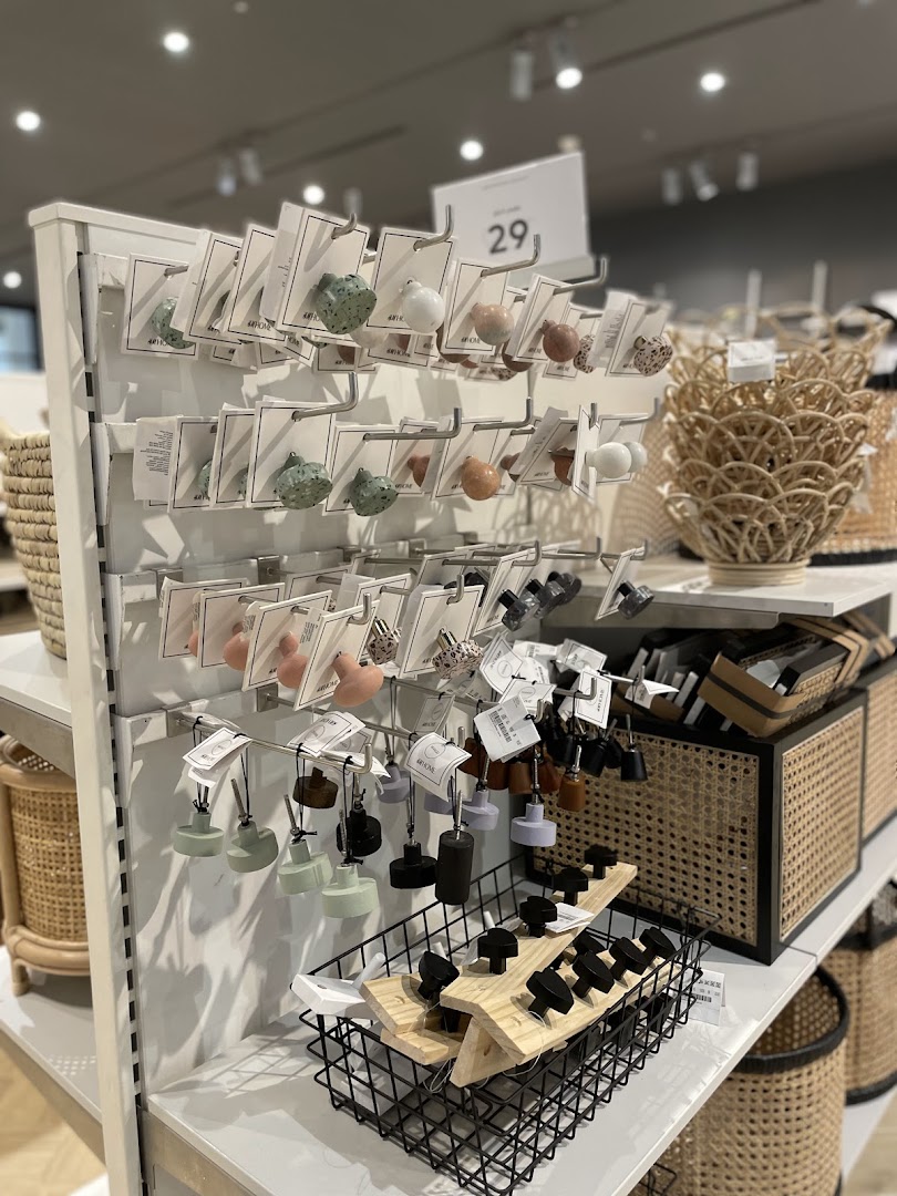 Display of various decorative knobs and baskets at H&M Home.