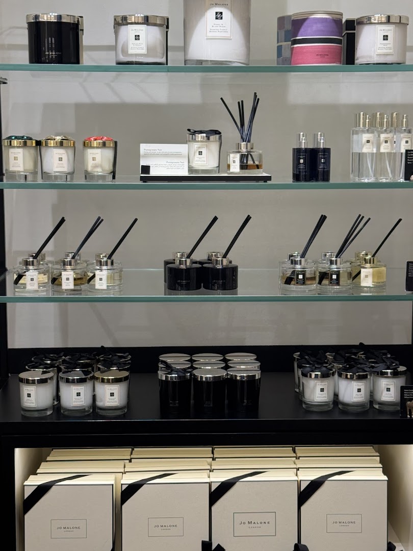 Shelves displaying Jo Malone candles, diffusers, and boxed gift sets.