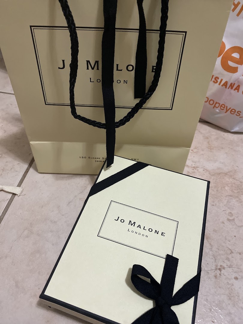 Jo Malone shopping bag and gift box with black ribbon.