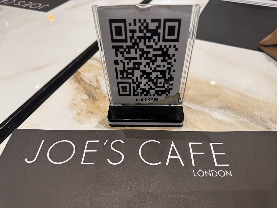 A table at Joe's Cafe with a QR code for the menu and the cafe's branding.