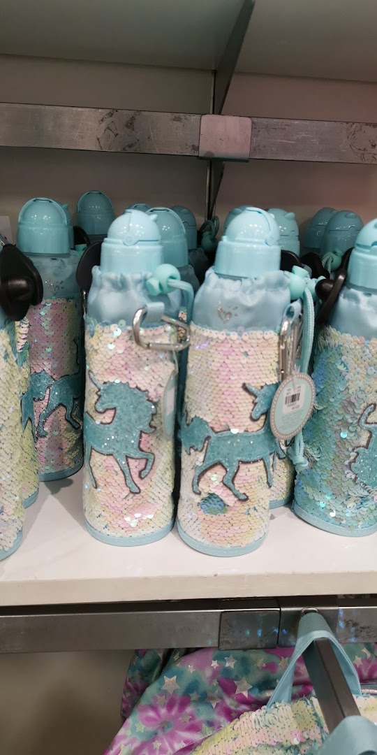Light blue water bottles with unicorn designs and iridescent sequins on a shelf.