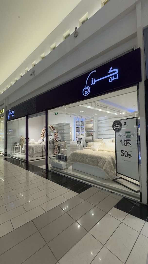 Karaz Linen shop front displaying bedding and promotional signs.