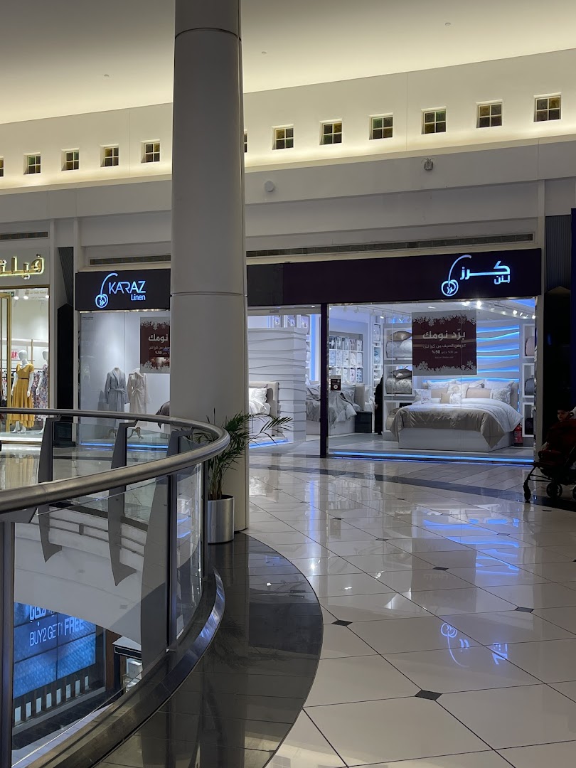 The Karaz Linen shop front displays elegant bedding and home decor items.