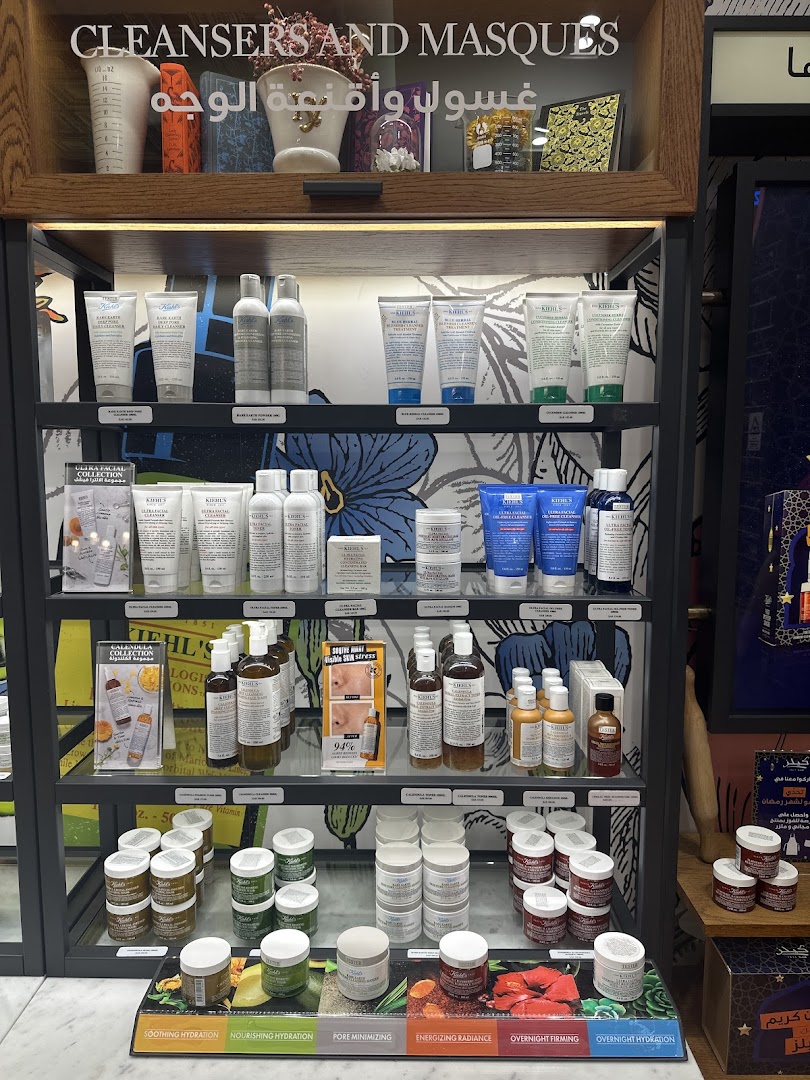 A display of Kiehl's skincare products, featuring cleansers, masques, and moisturizers.