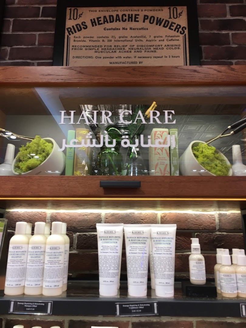 Kiehl's shop display featuring hair care products and vintage advertisements.