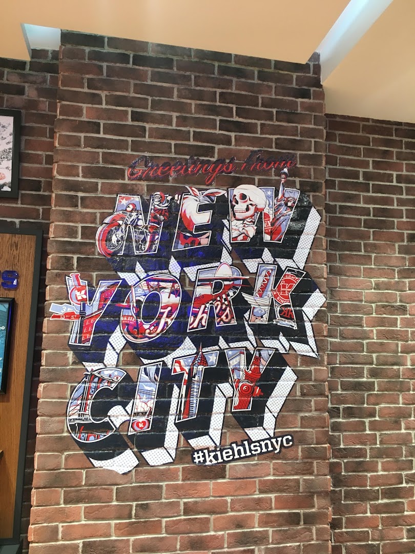 Kiehl's store features a New York City themed mural on a brick wall.