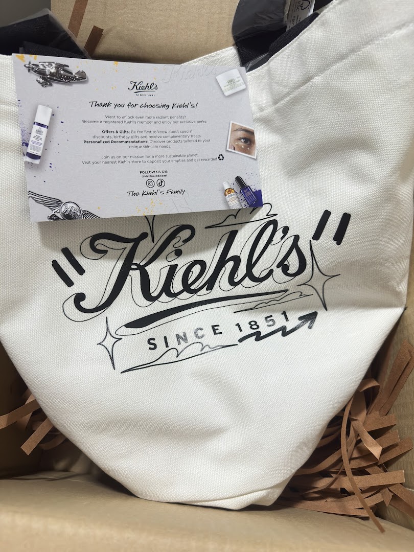 A white tote bag with the Kiehl's logo and a thank you card inside a box.