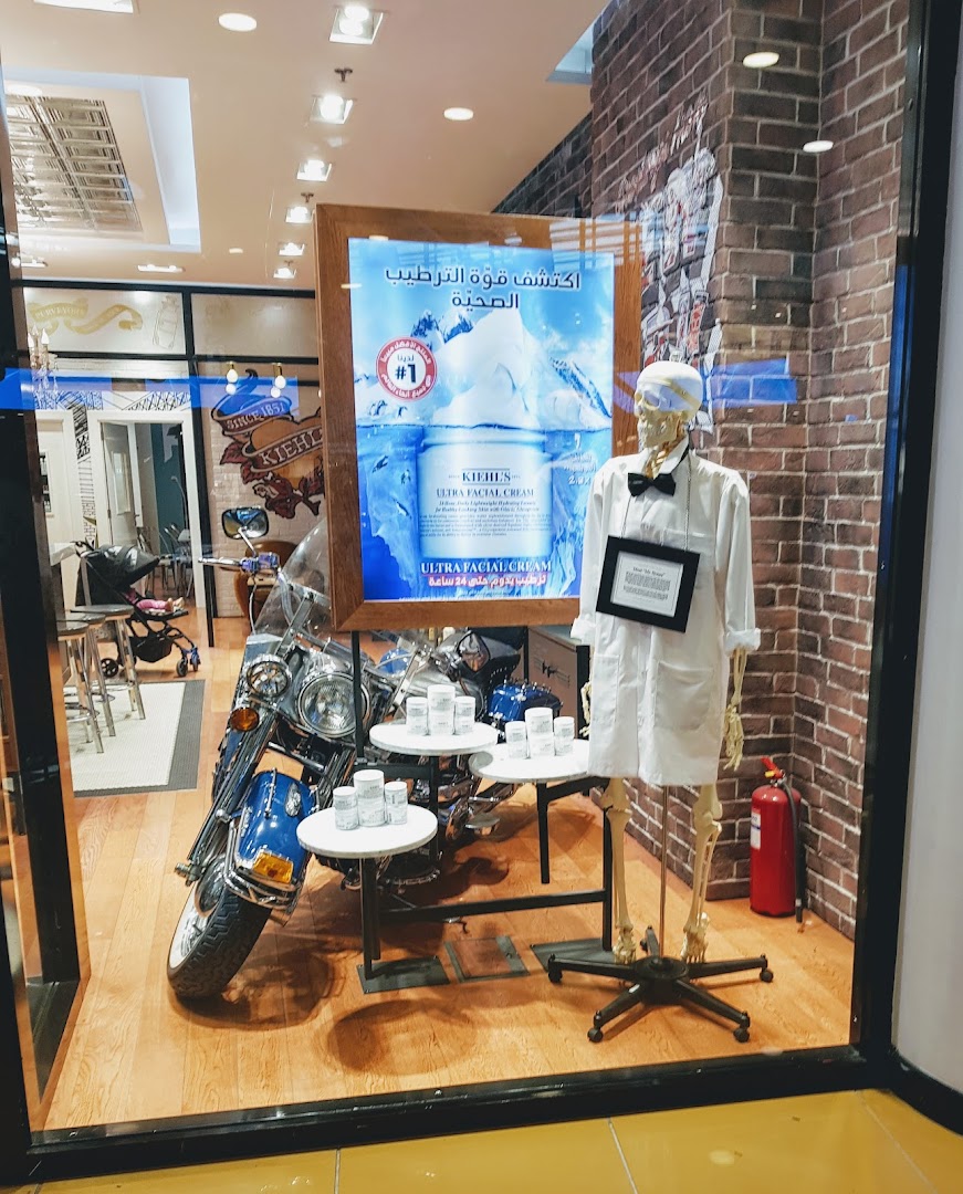 Kiehl's shop window display featuring a skeleton, a motorcycle, and skincare products.