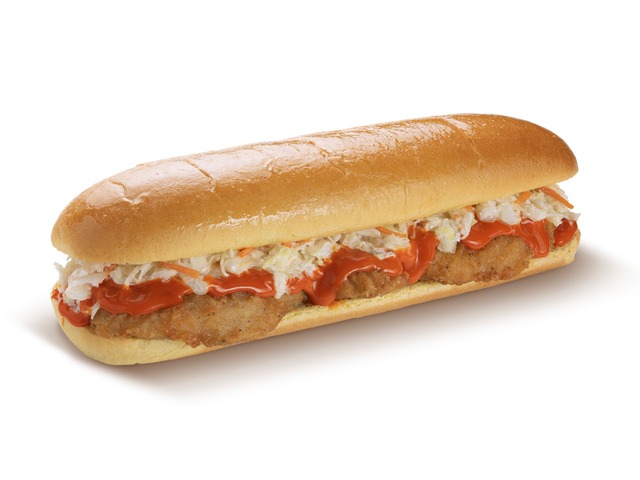 A delicious sandwich with crispy chicken, coleslaw, and spicy sauce on a long bun.