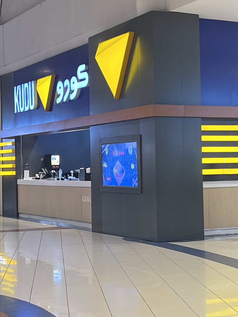 The Kudu shop front features a prominent blue facade with illuminated signage and a modern counter.