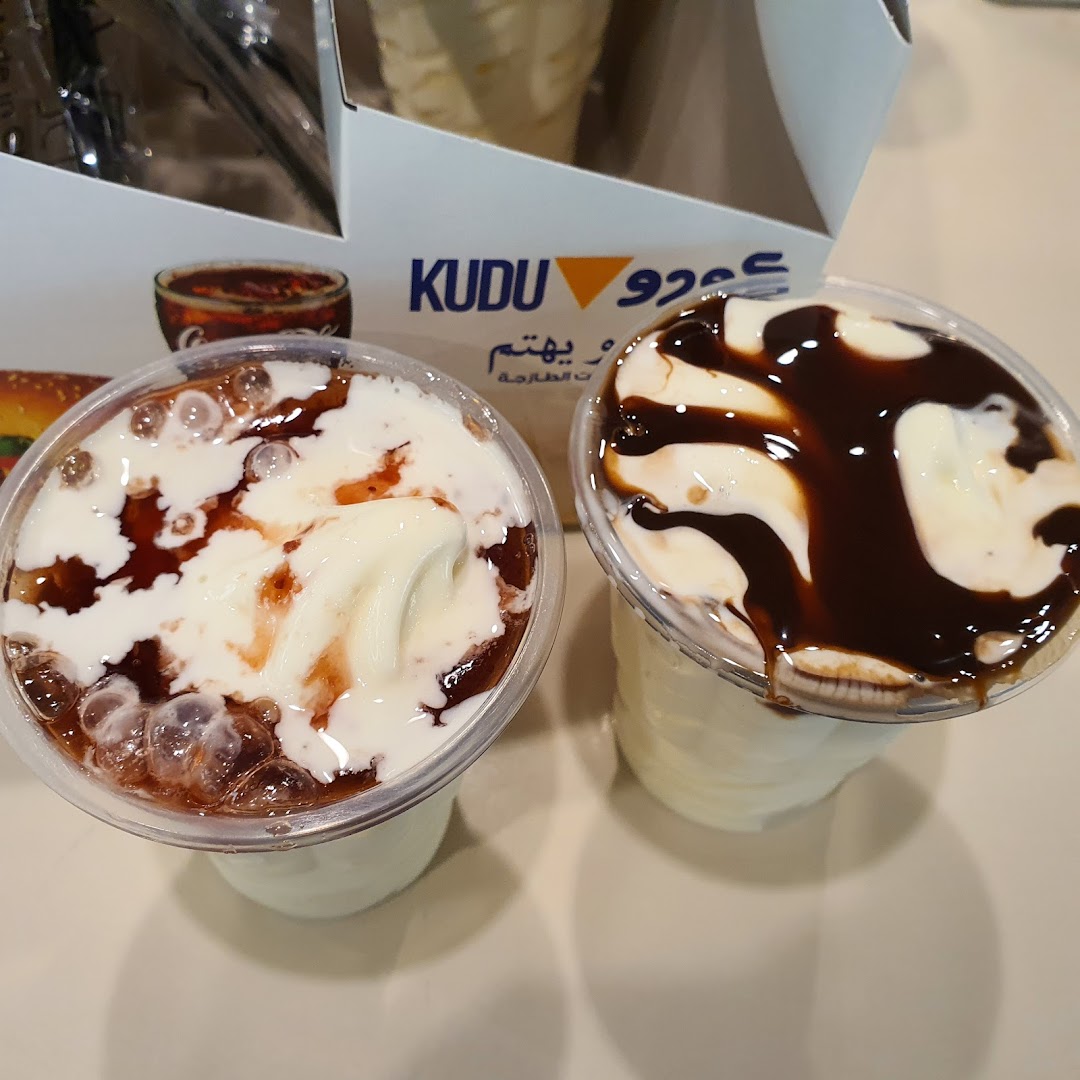 Two ice cream desserts with toppings, one with chocolate sauce and the other with a caramel sauce and bubbles.