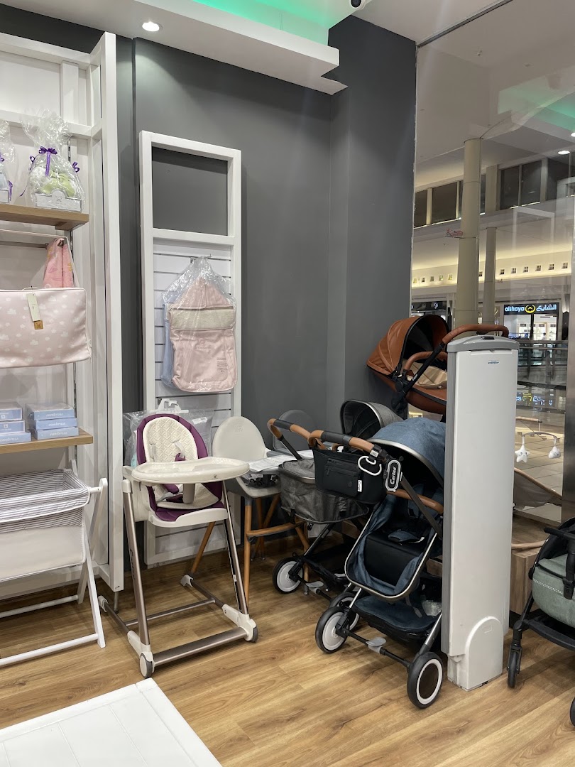 Interior view of a baby products store showcasing strollers, high chairs, and baby bags.