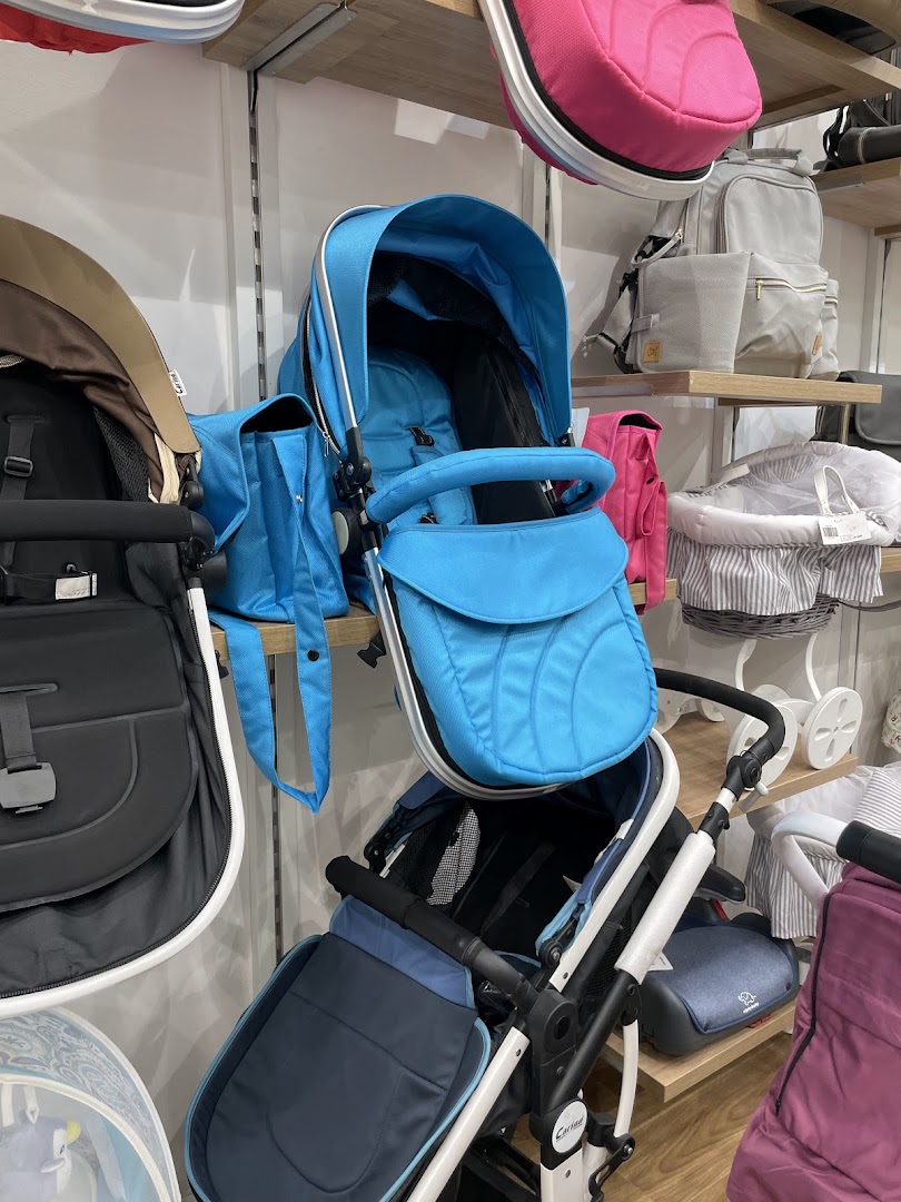 A display of various baby strollers and accessories in different colors and styles.