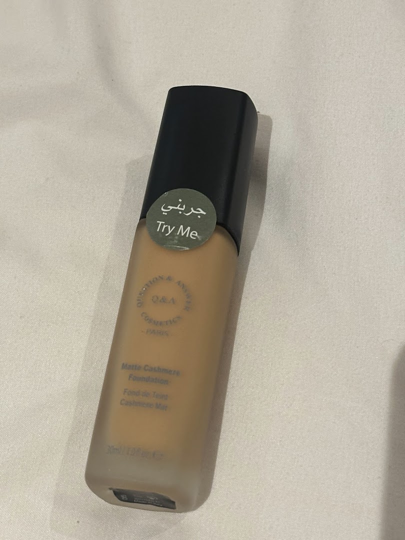 A bottle of Q&A Cosmetics Matte Cashmere Foundation in a light shade.
