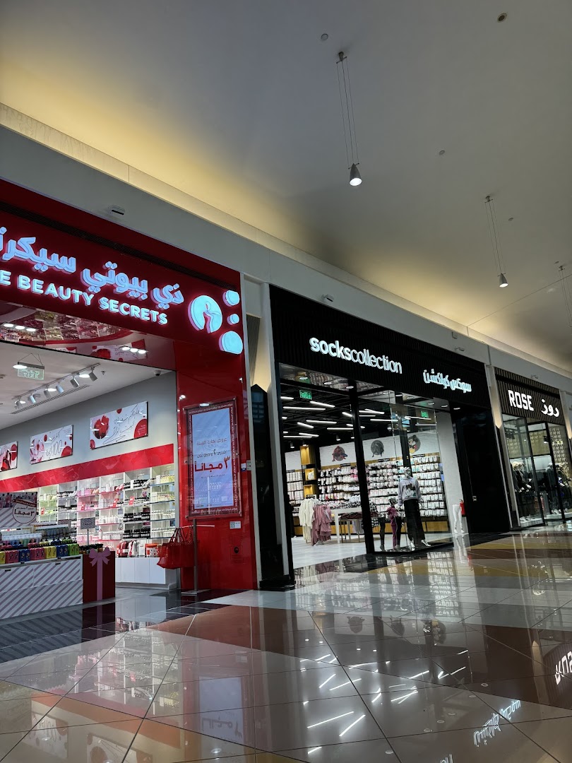 The storefronts of 'The Beauty Secrets' and 'Socks Collection' shops in a mall.