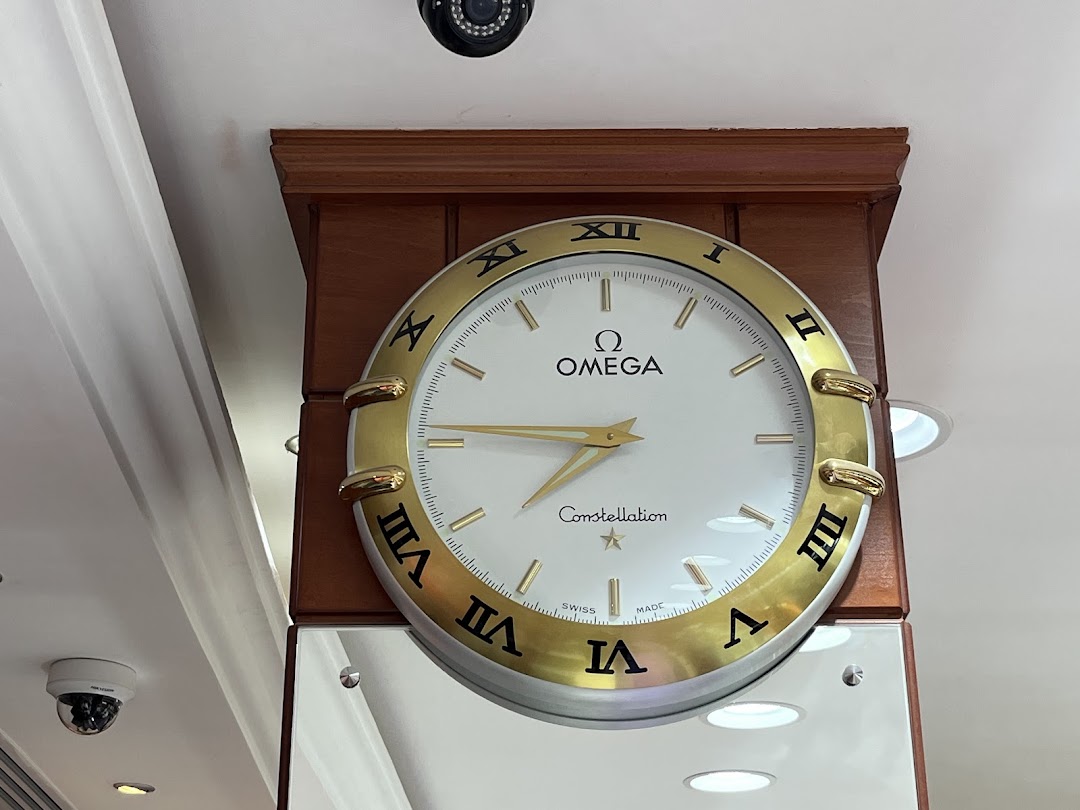 An Omega Constellation clock with Roman numerals and gold accents is displayed.