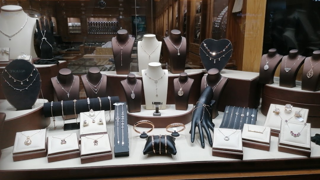A display of exquisite necklaces, bracelets, and rings in a jewelry store window.