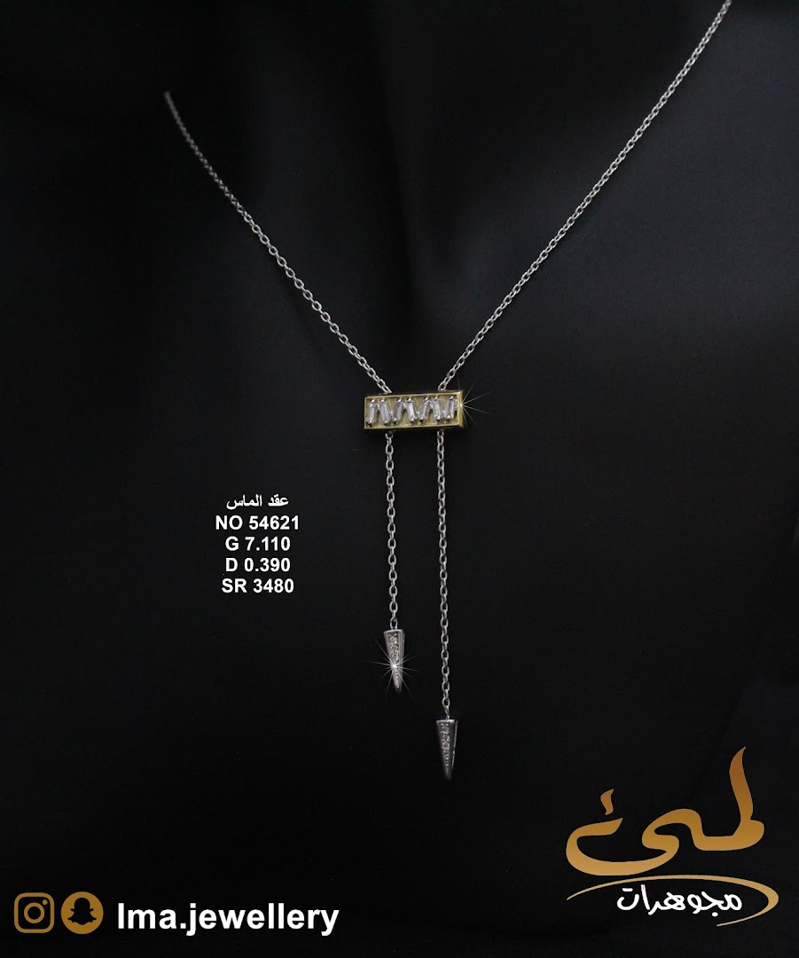 A diamond necklace with a gold bar and dangling pendants on a black background.