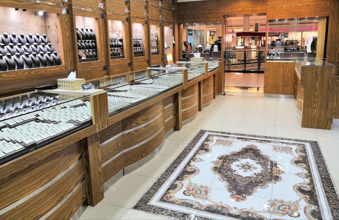 Interior view of a jewelry store with display cases filled with necklaces and earrings.