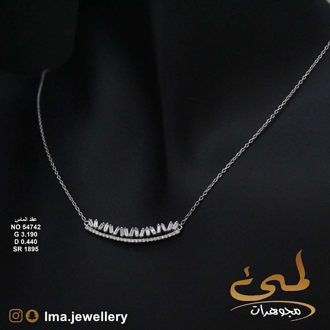 A silver necklace with baguette-cut diamonds on a black background.