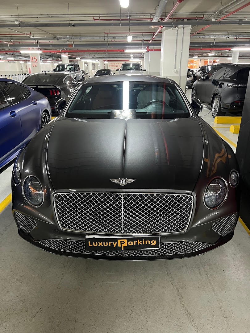 A luxury Bentley car parked in a well-lit underground parking garage.