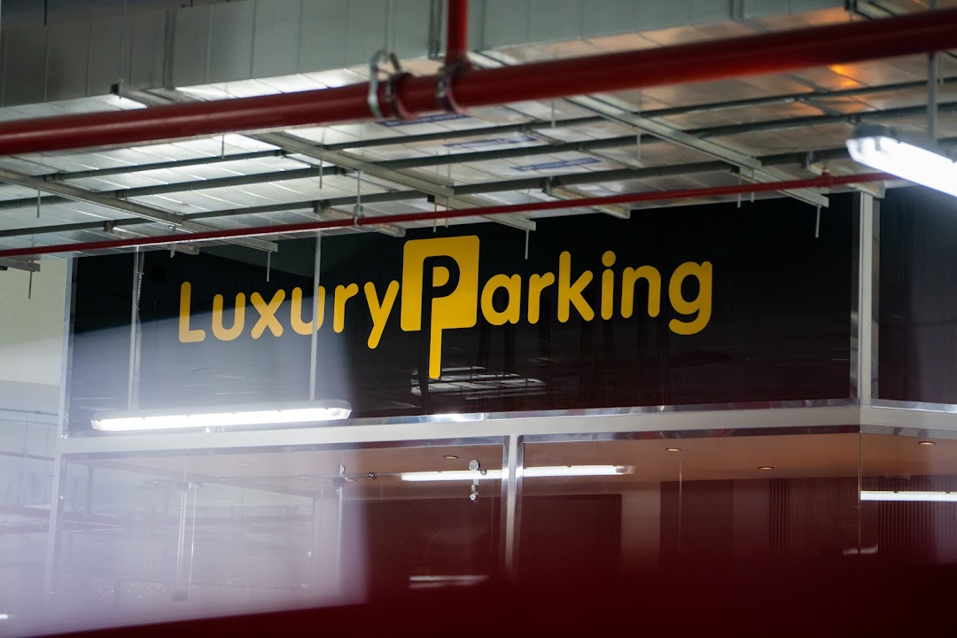 A sign for Luxury Parking with a large yellow 'P' logo.