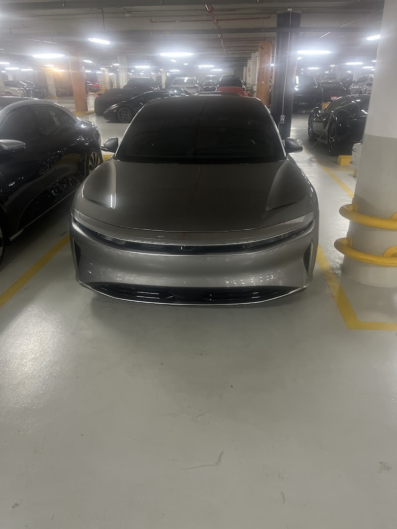 A sleek, modern electric car parked in a well-lit underground parking garage.