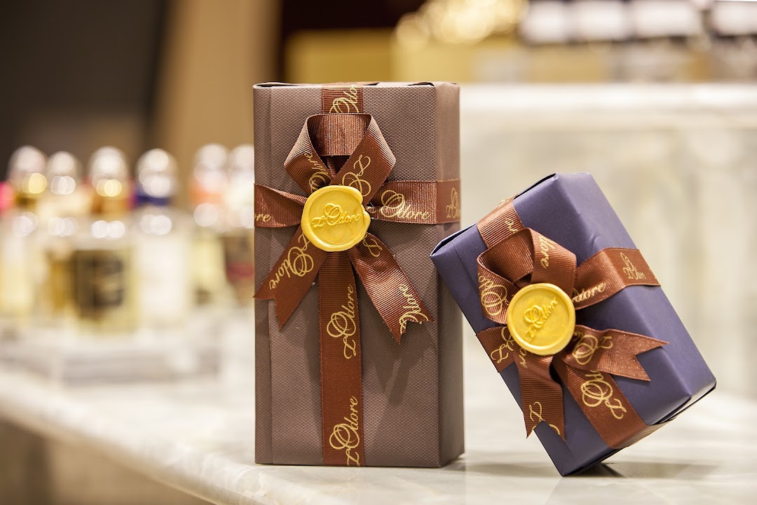 Two elegantly wrapped gift boxes with ribbons and wax seals from L'Odore.