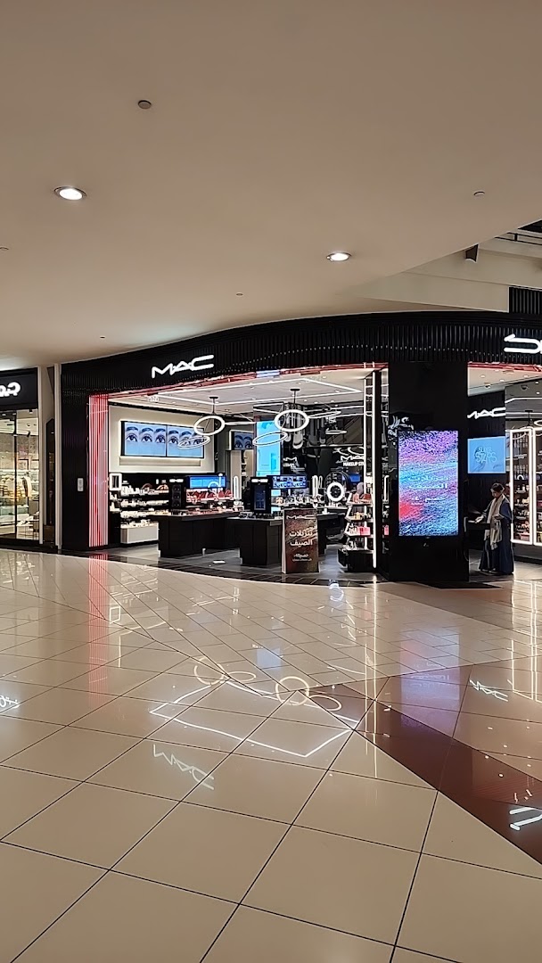 The M.A.C cosmetics store entrance with illuminated displays and products.