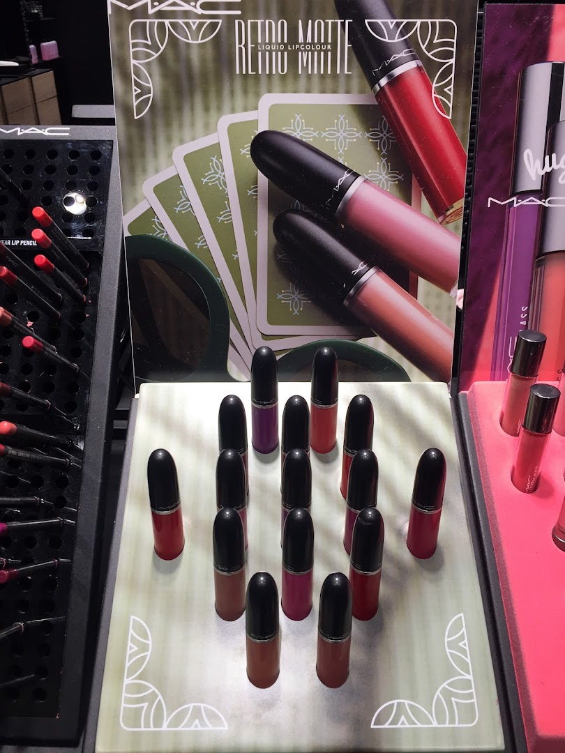 A display of MAC Retro Matte Liquid Lipcolour and lip pencils in various shades.
