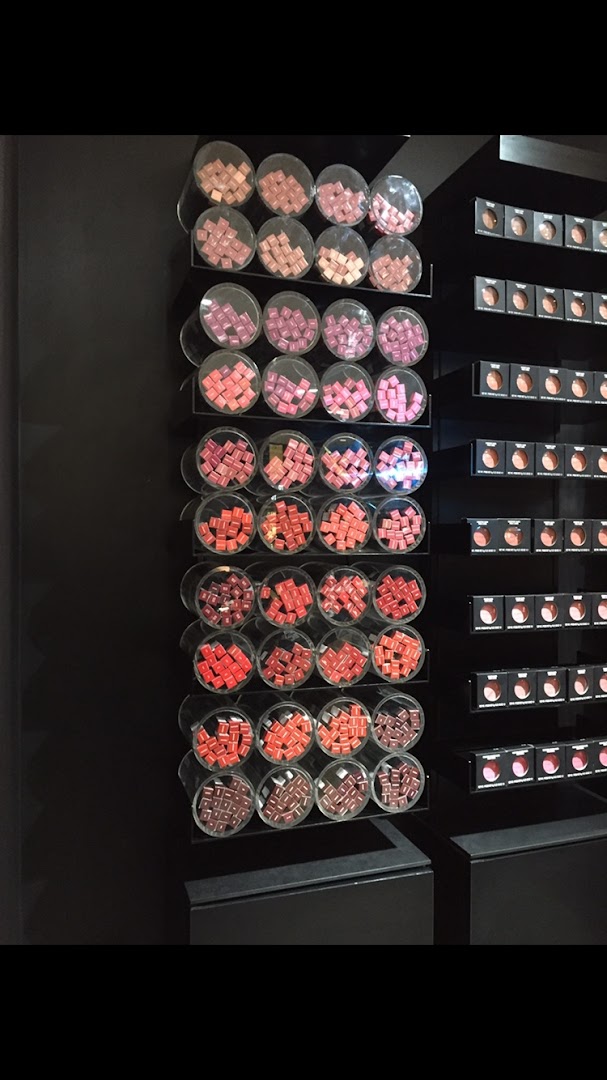 A display of various shades of lipstick and eyeshadows at a M.A.C store.